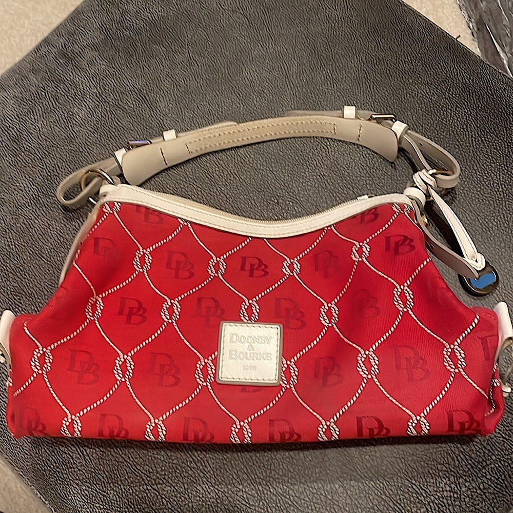 Dooney & Bourke red canvas bag with cream leather trim.